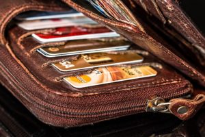 open wallet with credit cards pay off debt